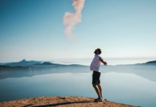 Cross Country color photo of person out in nature with arms outstretched.       