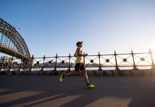 Cross Country color photo of person jogging along boardwalk.          