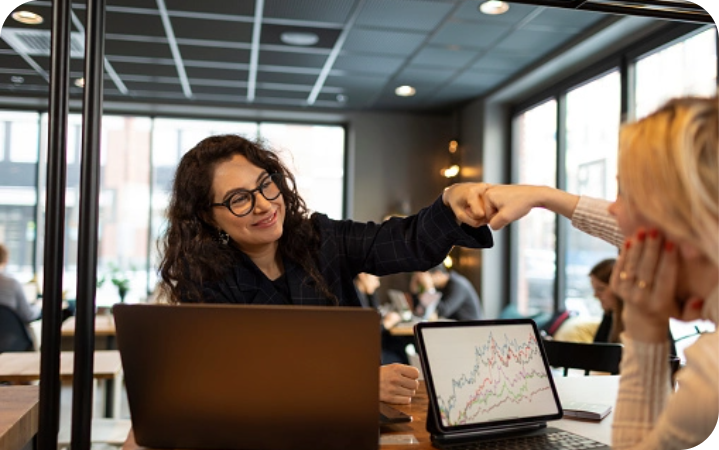 Cross Country color photo of two women fist bumping.