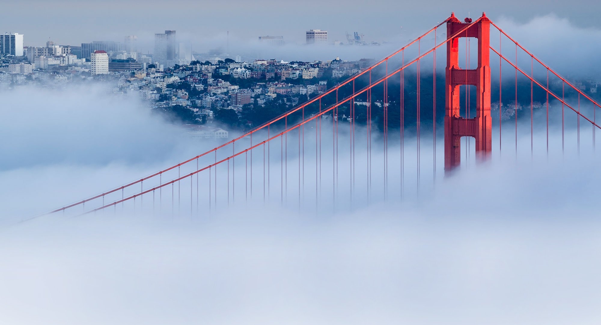 Cross Country Healthcare color photo of San Francisco in the fog with the Golden Gate Bridge in the foreground.              