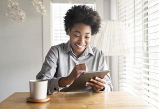 Cross Country color photo of person writing on tablet.            