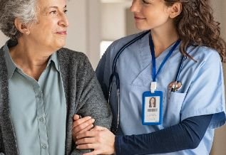 Cross Country color photo of nurse assisting elderly patient.               