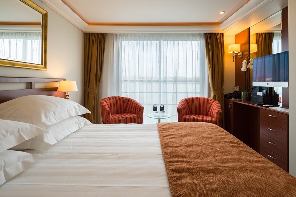 Category A French Balcony stateroom aboard AmaDolce with river views and elegant furnishings