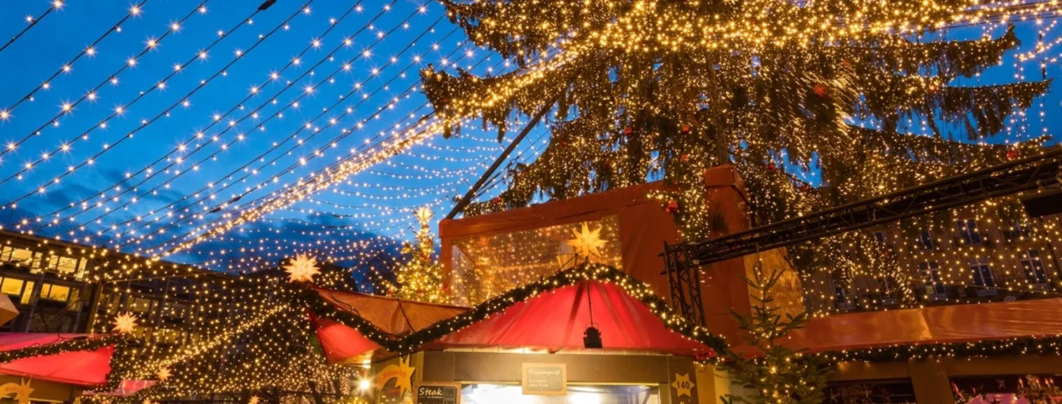 A European Christmas market stalls and string lights