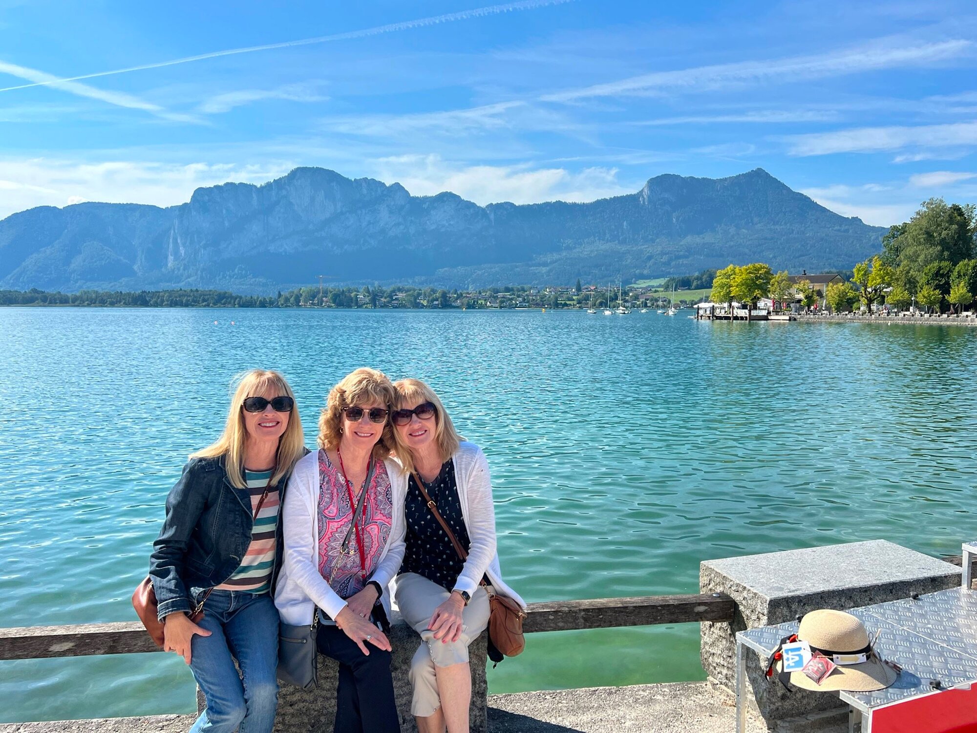 A family posing on a balcony of a ship with a view of Austria's lake district