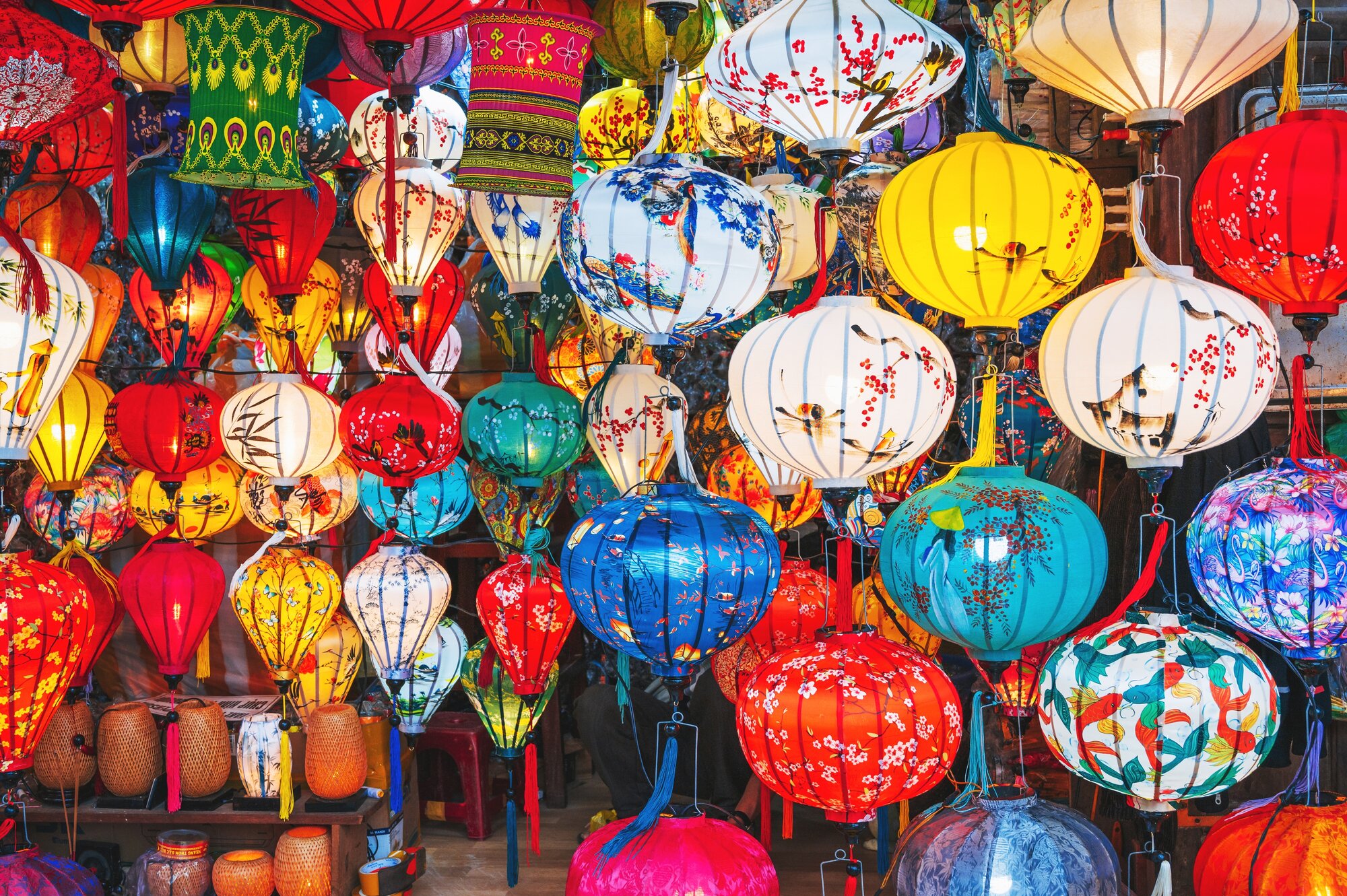 background with colorful Vietnamese hanging glowing silk lanterns in Vietnam in Hoi An city in night market in Asia
