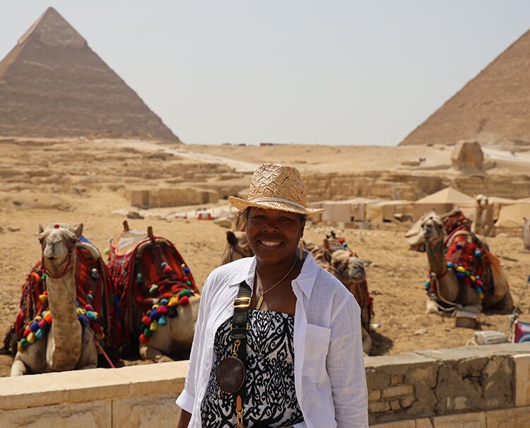 Christine posing in front of the pyramids in Egypt