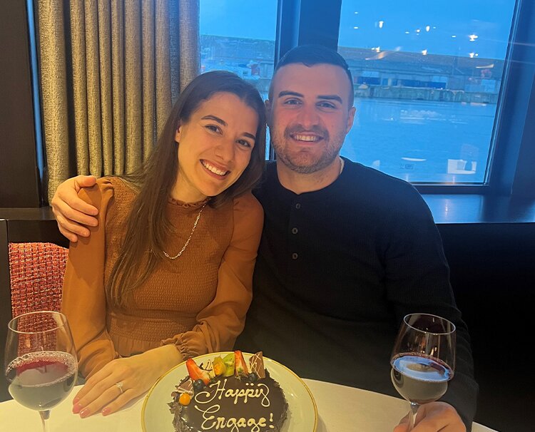 Newly engaged guests celebrating with a cake