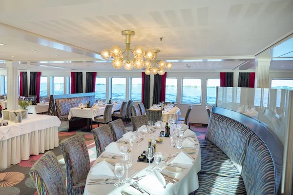 Elegant dining room aboard a cruise ship with panoramic ocean views