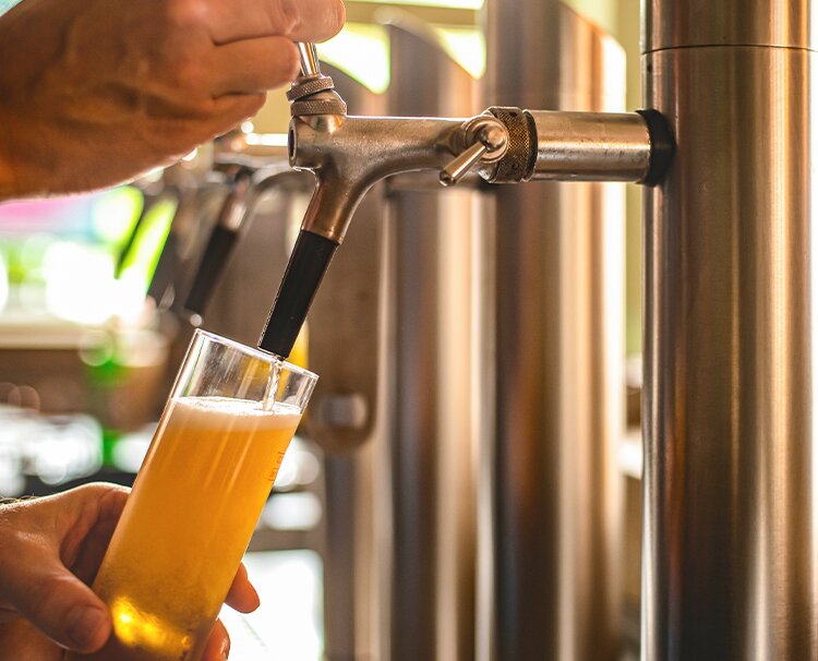 Beer being poured onto a glass