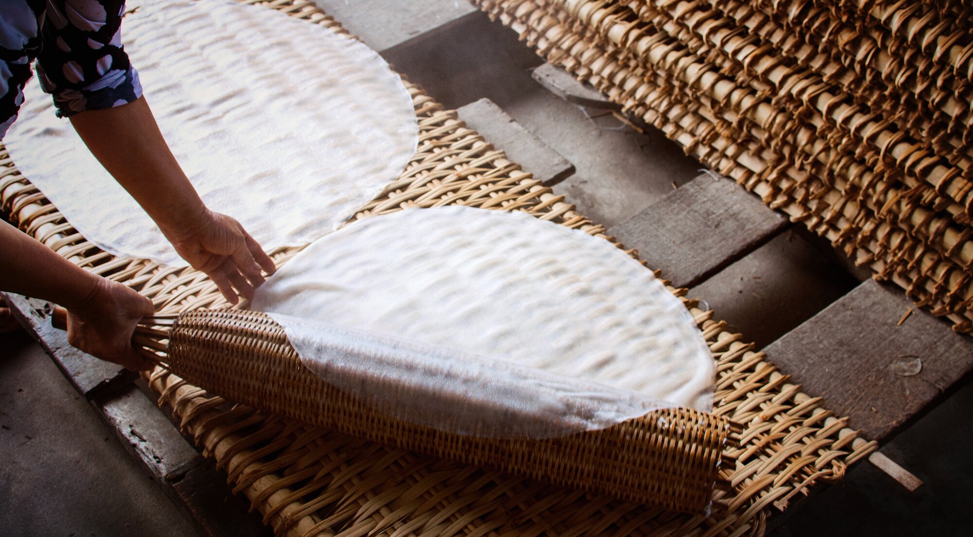 woman wearing ao dai dress with Incense sticks drying outdoor in Hanoi, Vietnam.