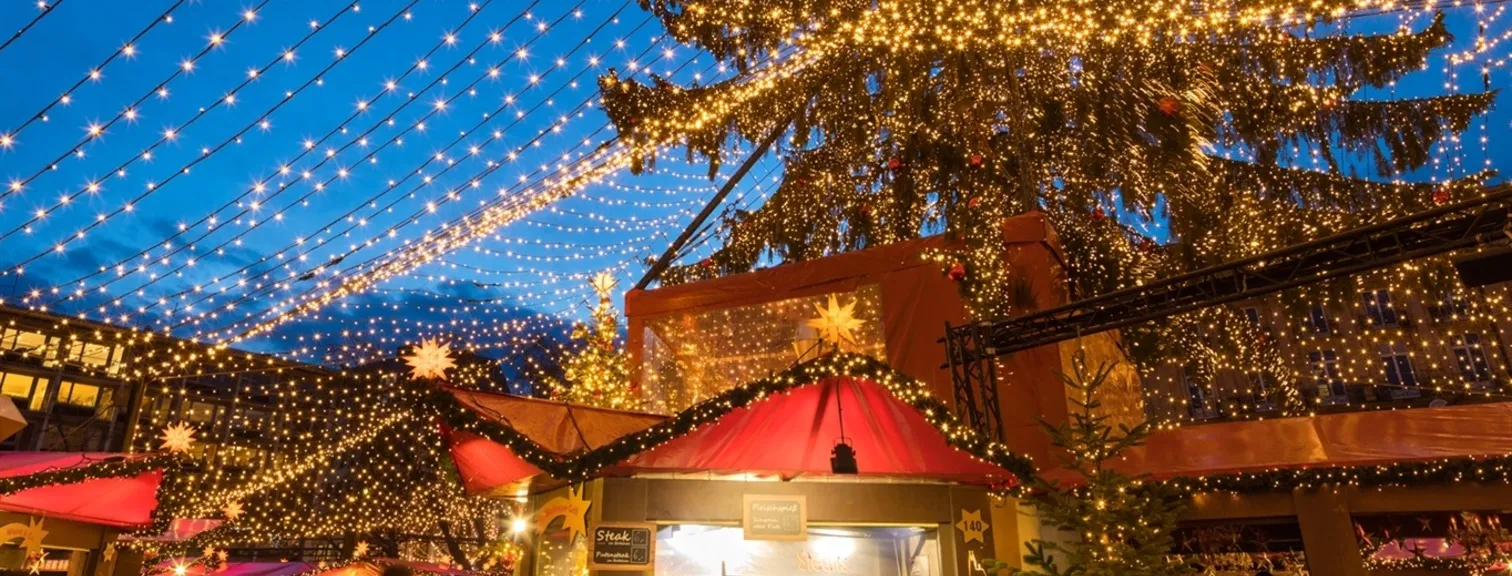 A European Christmas market stalls and string lights