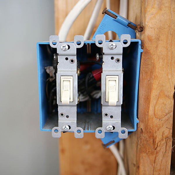 An electrical box installed in a framed room.