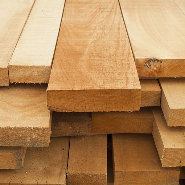 Lumber boards stacked together.