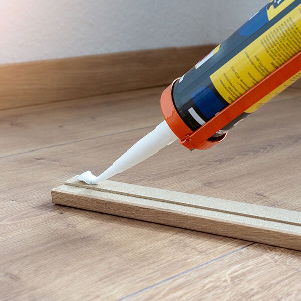 Glue is being applied to interior wood trim.