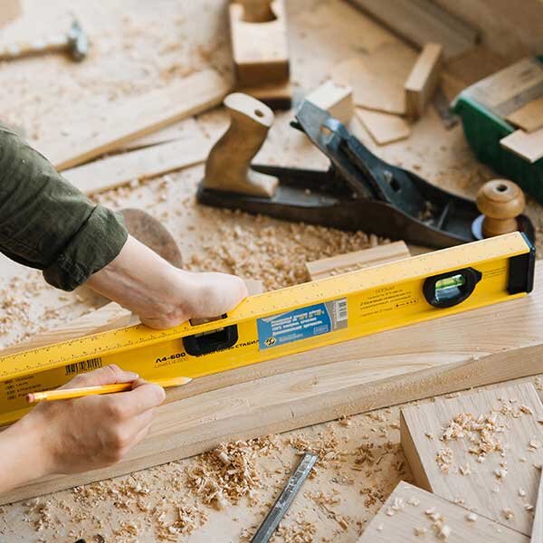 A level being used to level a piece of lumber.