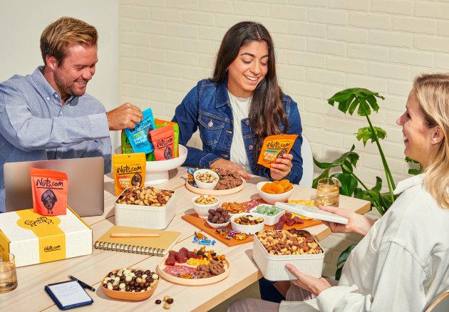 Group of people enjoying various nuts.com snacks 