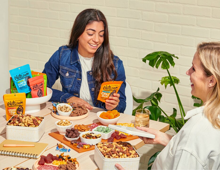 Group of people enjoying various nuts.com snacks 