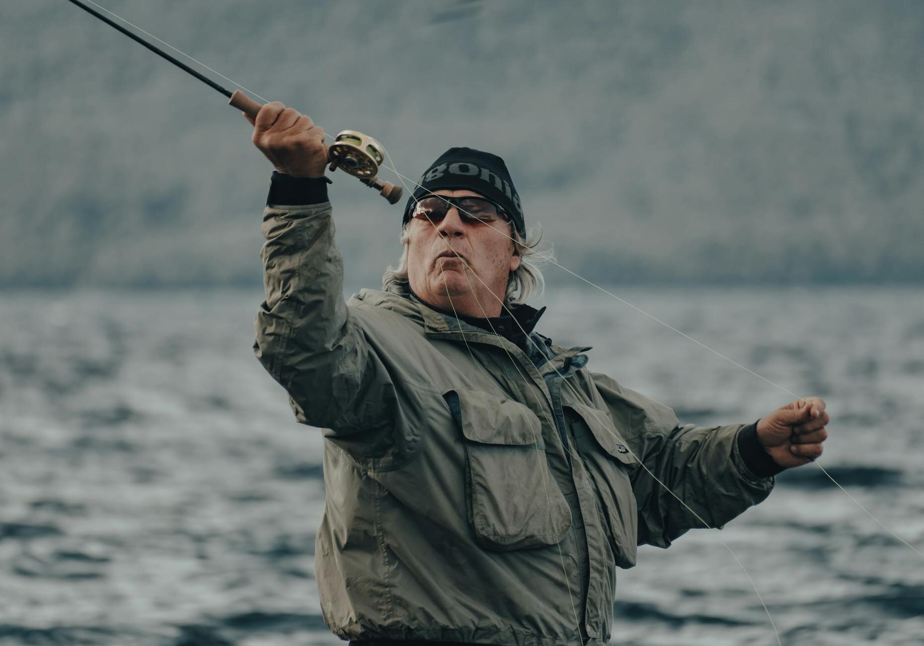 an elderly guy casting his fishing line