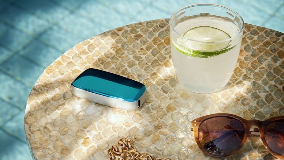 Poolside with a drink, sunglasses, and jewelry