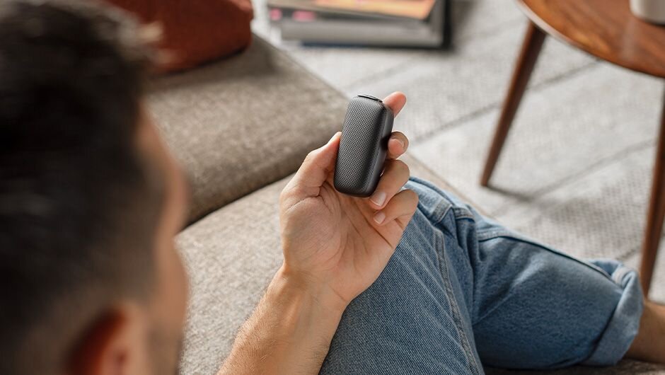 After Wolt order, a man is unboxing a Ploom device.