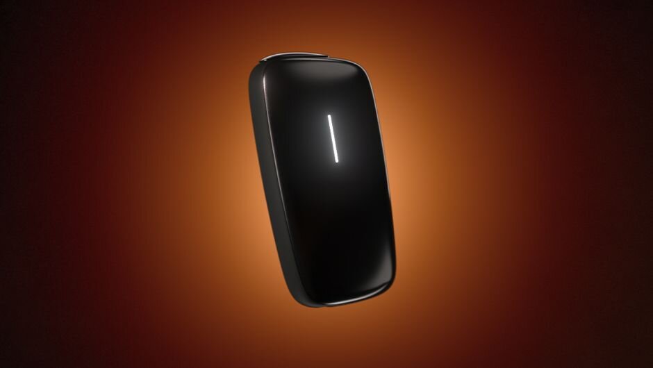 Black Ploom tobacco heating device on an orange background.