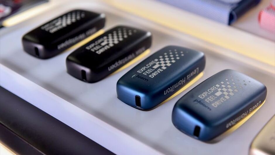 Ploom devices on display at the stand with the slogan 'Explore, Feel, Drive' printed on them. 