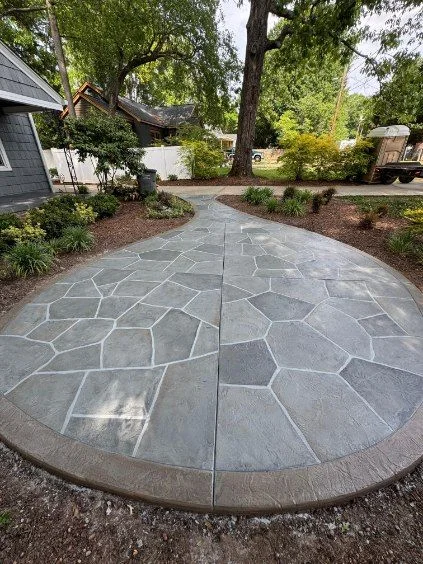 Curving gray flagstone-pattern concrete walkway