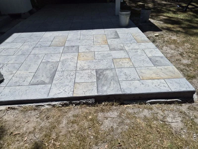 Ashlar-pattern stamped concrete patio in gray and tan tones