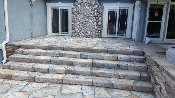 Flagstone-pattern concrete steps at a home entry