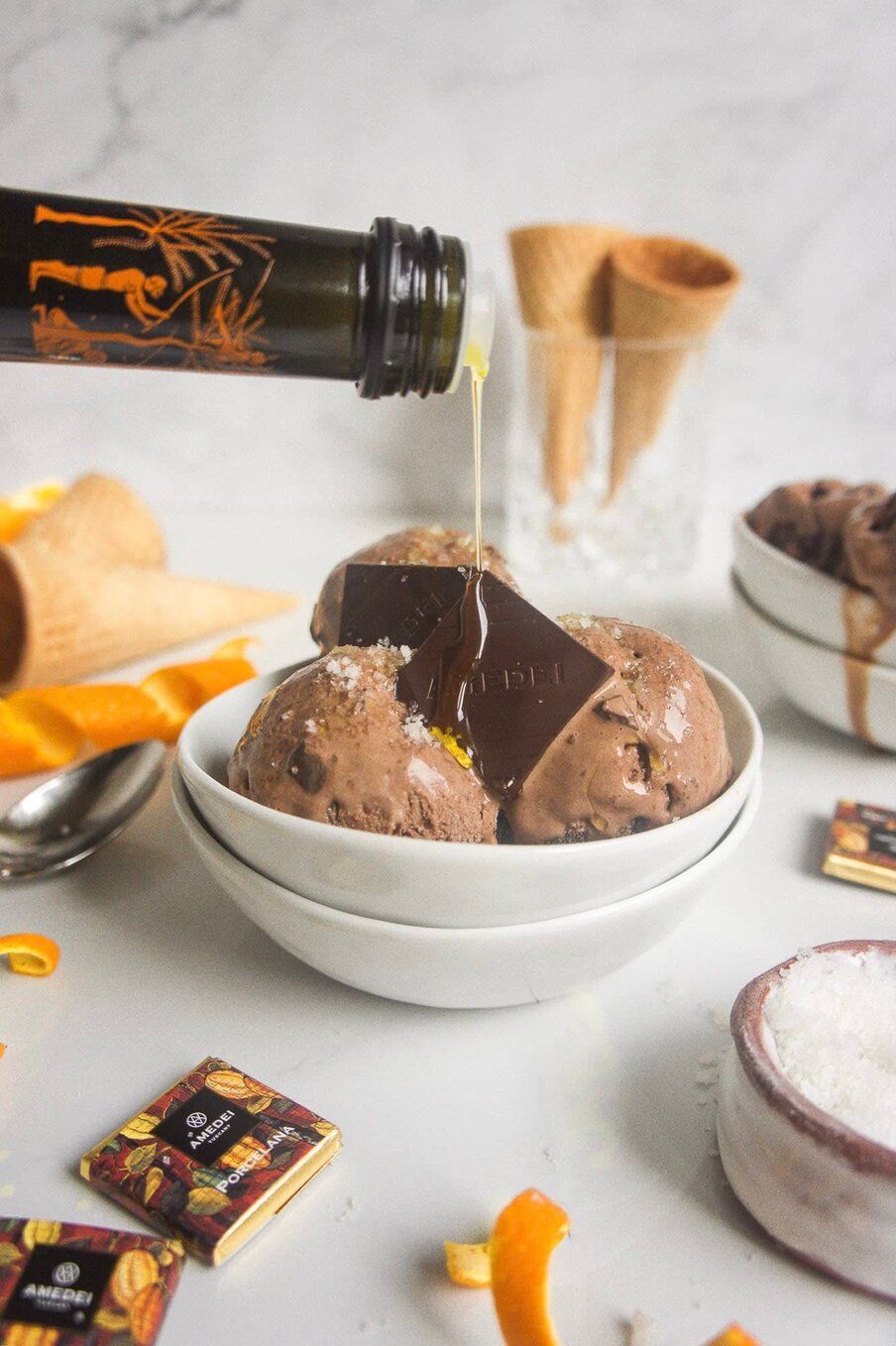 Extra virgin olive oil poured over chocolate gelato with candied orange and dark chocolate