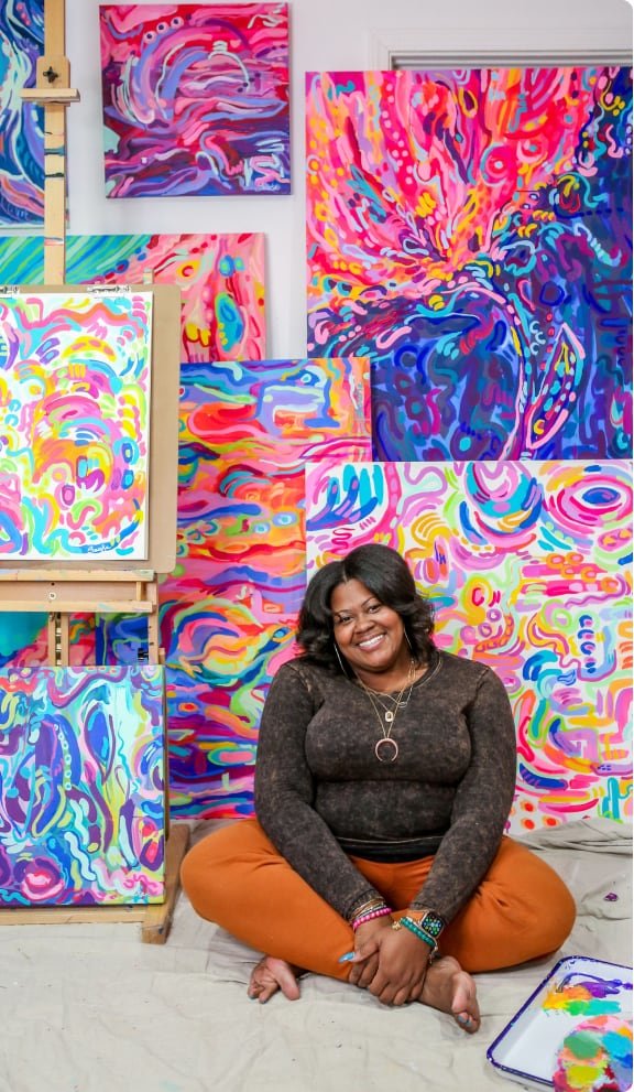 Sareka Unique Sitting in front of her artwork made with Nova Color Acrylic Paint