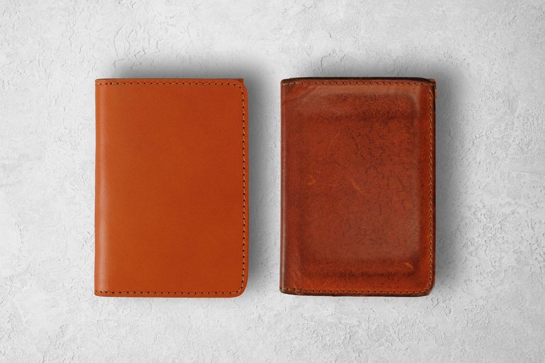Two brown leather wallets beside one another showing patina development over time