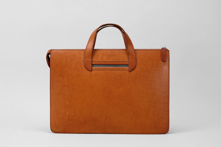 Slim cognac leather briefcase with pronounced patina development
