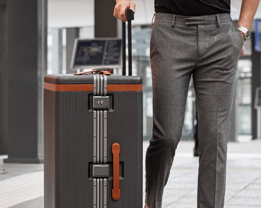 Open suitcase with clothes inside a pari of black shoes next to it