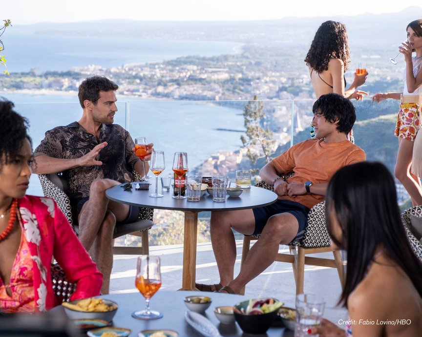 Two lead actors in TV series The White Lotus sat at a table overlooking Sicilian coast