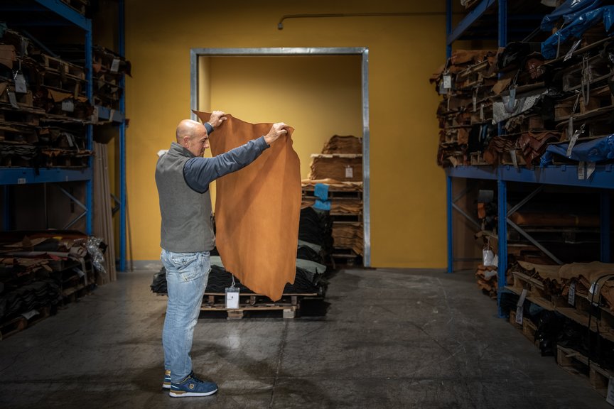 Tanner holds a sheet of vegetable-tanned leather