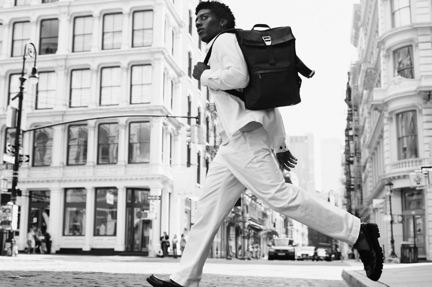 Man crosses New York street wearing white outfit and black nylon backpack