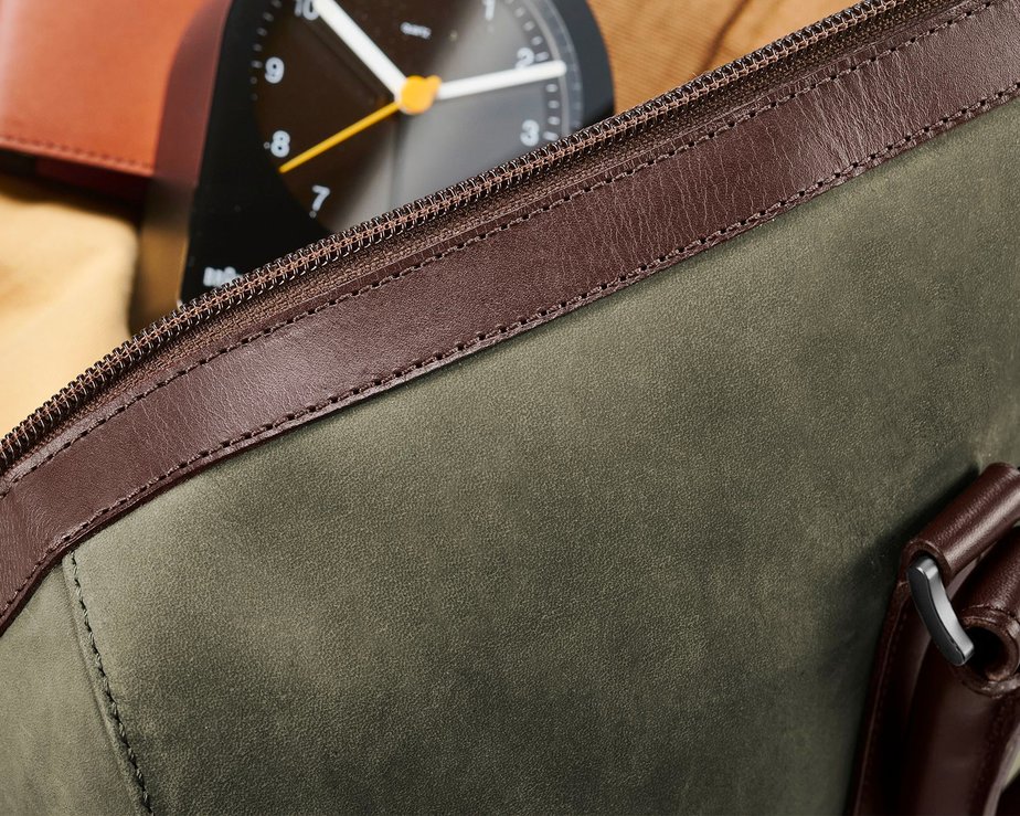 Zoomed in image of olive green nubuck leather bag showing soft texture