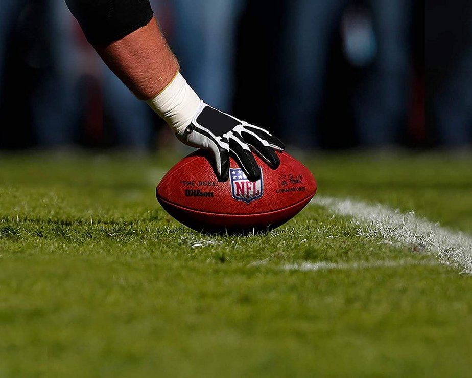 NFL player completing a touchdown with pebbled leather football