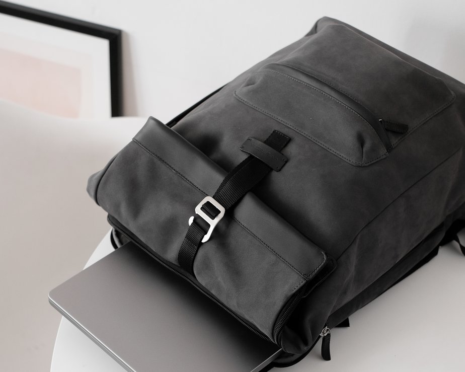Charcoal nubuck leather backpack with silver laptop inside