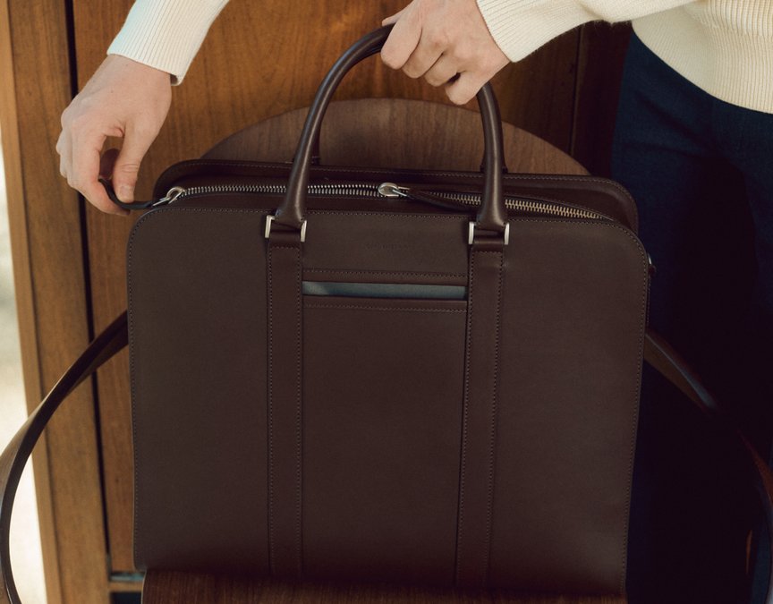 Sleek brown leather briefcase placed on chair