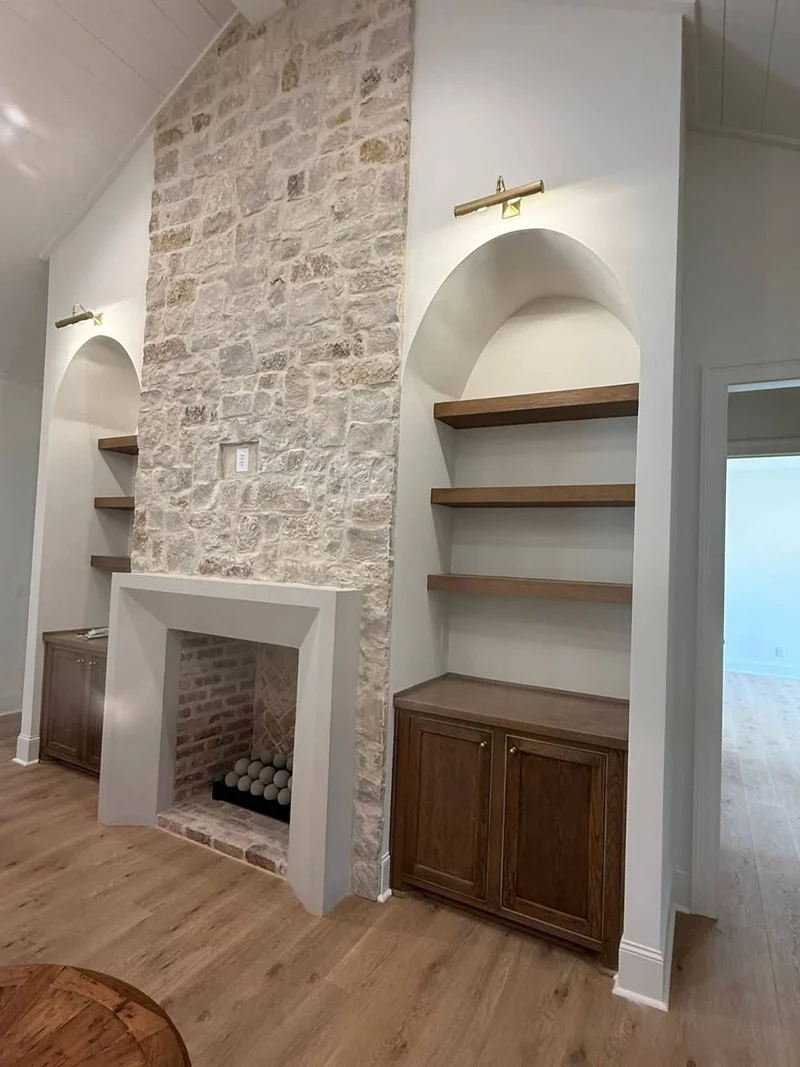 Stone fireplace with built-in cabinetry and open display shelving