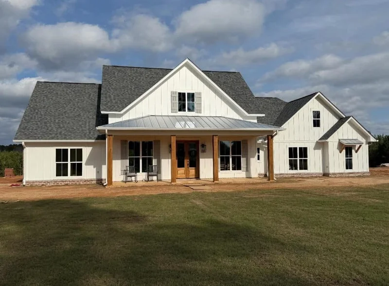 White farmhouse-style custom home with covered timber porch