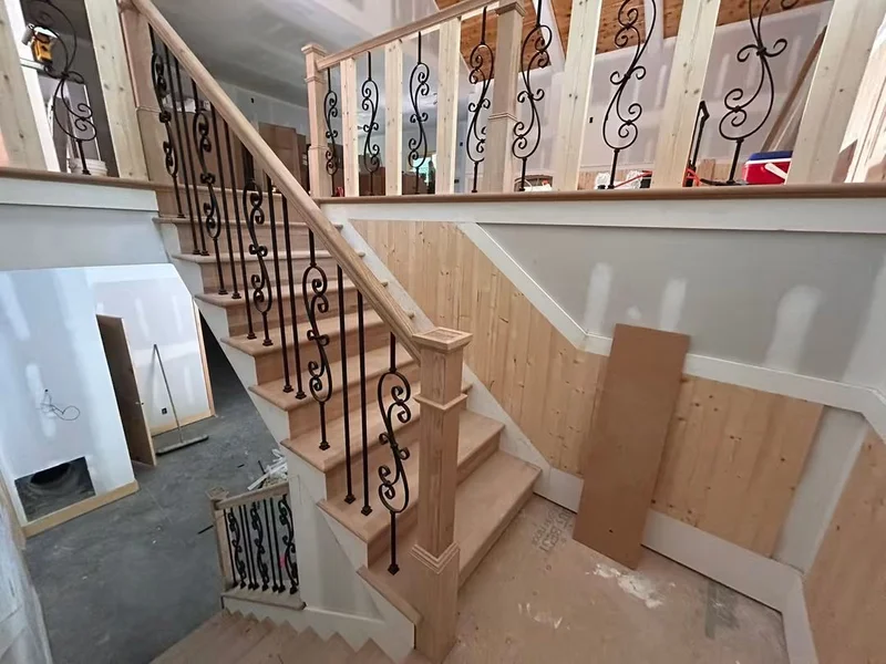 Interior staircase with custom iron balusters