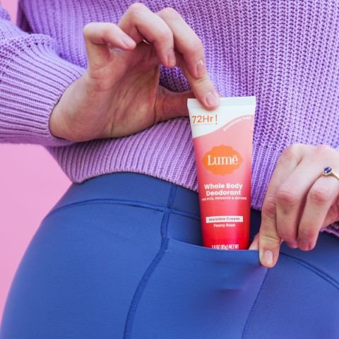 Woman holding cream deo tube