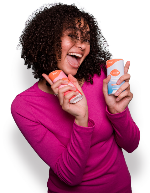 Woman holding Lume sticks with a big open smile