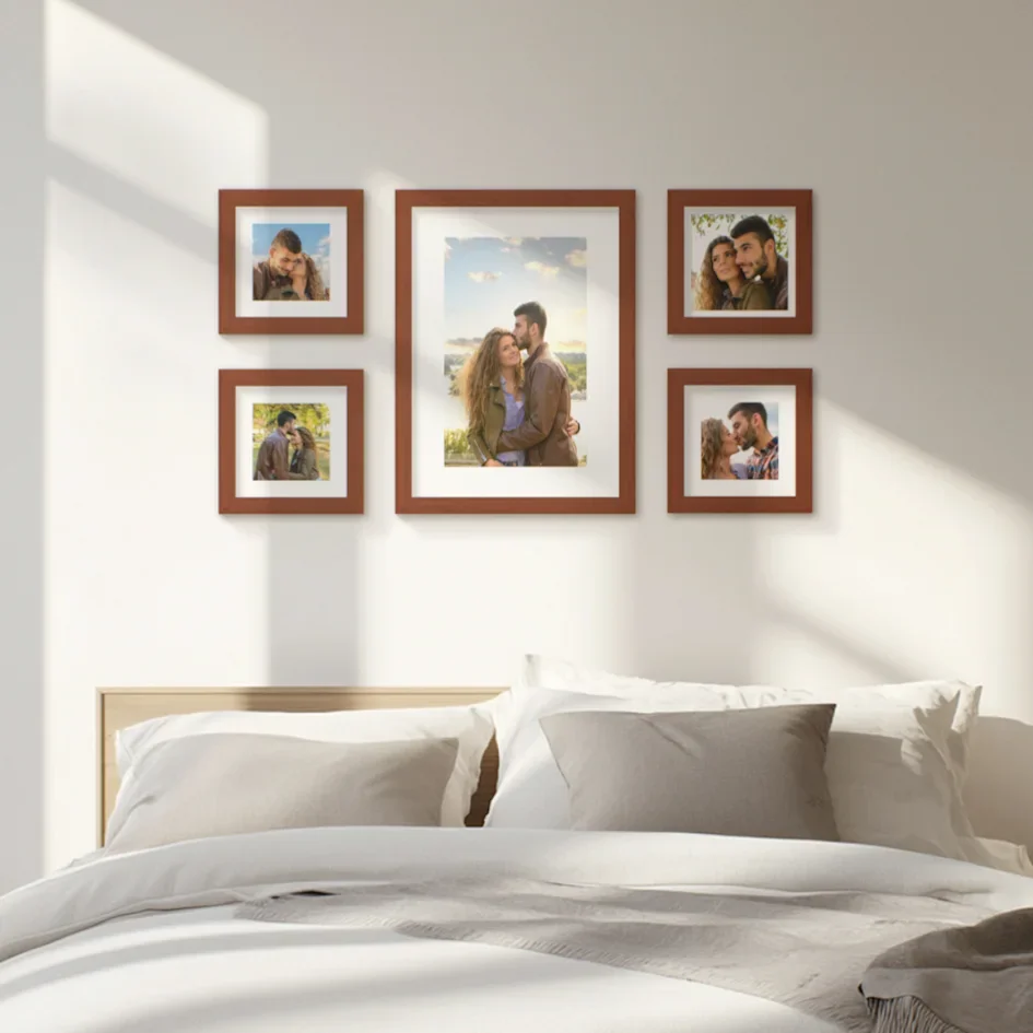 Bedroom wall with framed romantic photos in warm tones