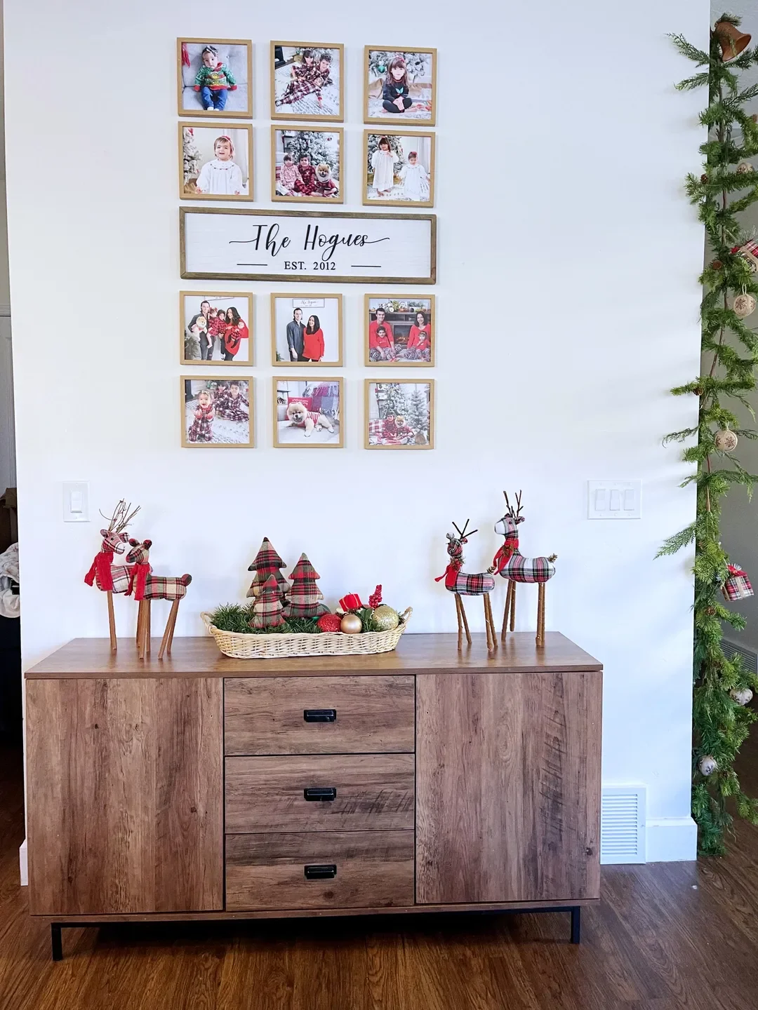 Christmas-themed home decor with decorations on console and wall.