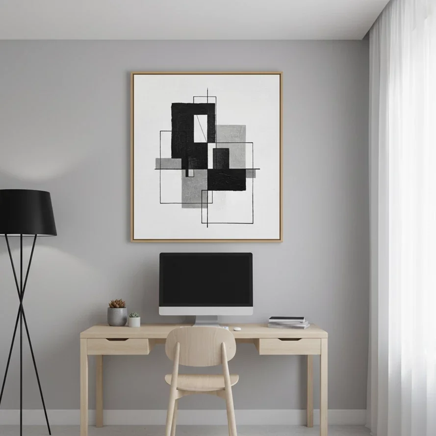abstract geometric painting hangs above minimalist home desk